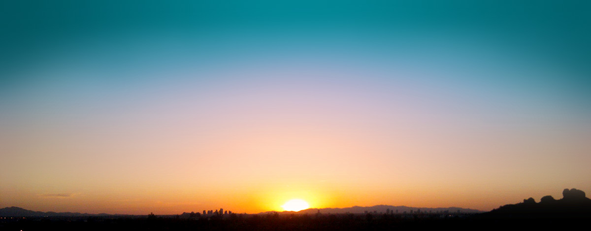 Sun setting with Phoenix, Arizona in the distance